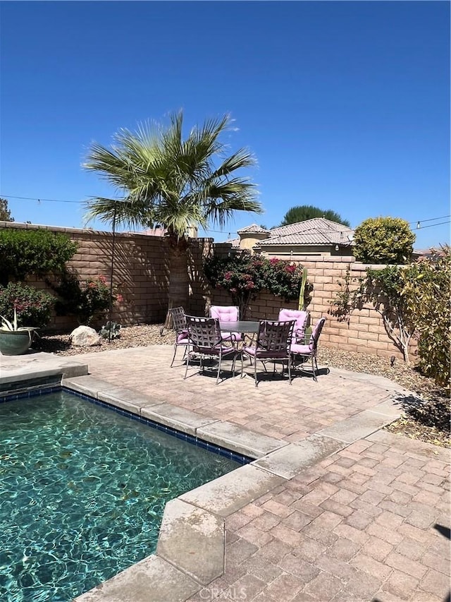 41097 Maiden Ct, Indio, CA 92203 - view of pool with a fenced backyard, a patio area, and an outdoor living space