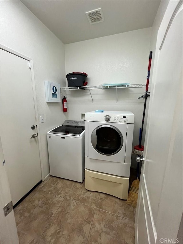 41097 Maiden Ct, Indio, CA 92203 - washroom featuring separate washer and dryer and light tile patterned floors