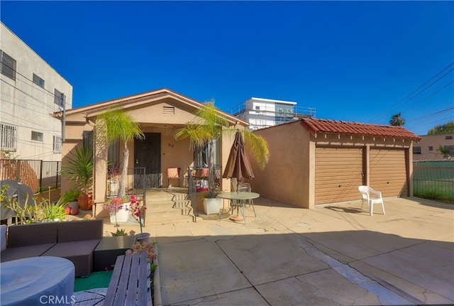 rear view of property with a patio and an outdoor hangout area