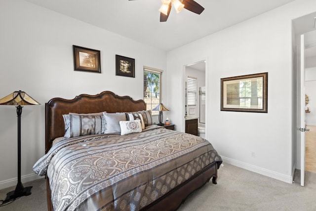 carpeted bedroom with ceiling fan and ensuite bathroom