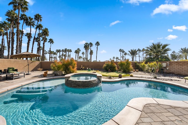 view of pool featuring a patio and an in ground hot tub