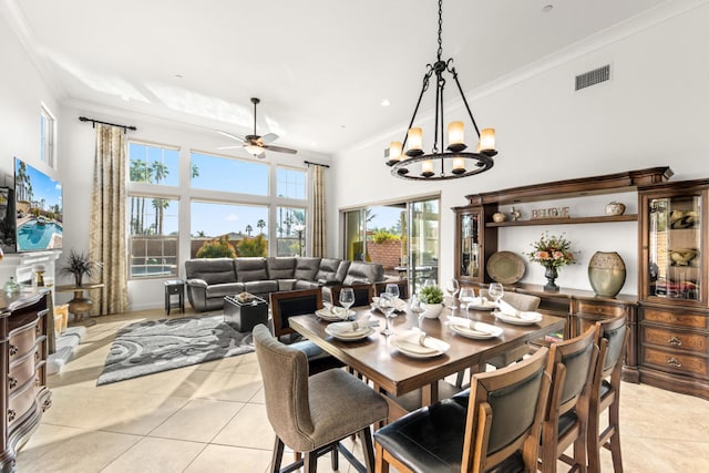 tiled dining room with ceiling fan with notable chandelier, crown molding, and a fireplace