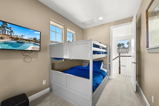 bedroom featuring light carpet