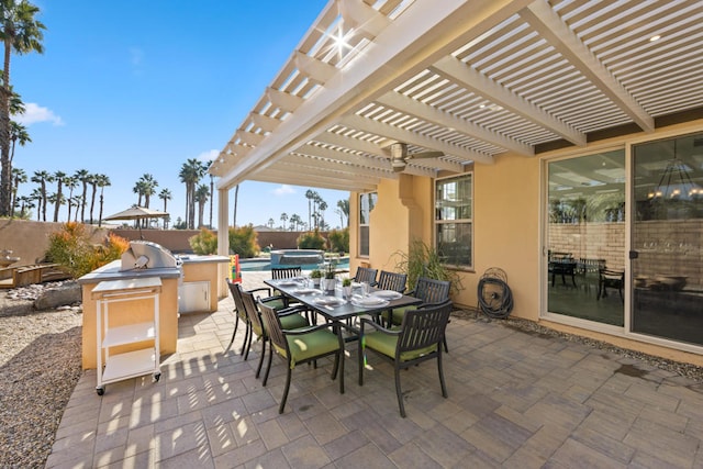 view of patio featuring an outdoor kitchen and a pergola