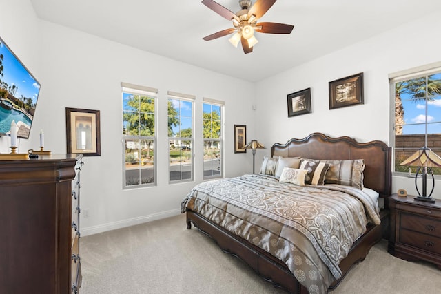 bedroom with light carpet and ceiling fan