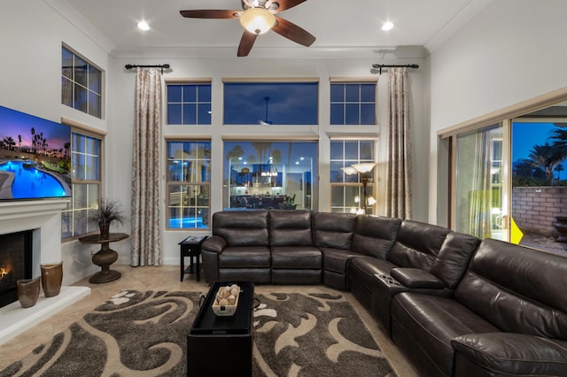 living room featuring crown molding, tile patterned flooring, a towering ceiling, and ceiling fan