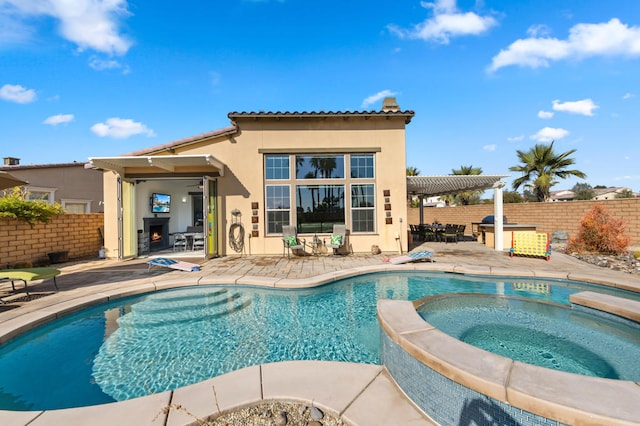 view of swimming pool featuring an in ground hot tub and a patio area