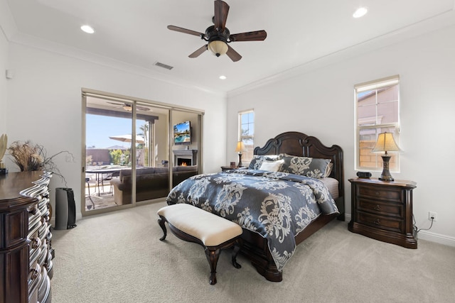 bedroom with access to outside, light carpet, multiple windows, and ceiling fan