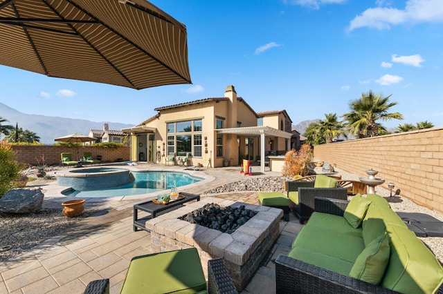 view of swimming pool with a patio, an in ground hot tub, an outdoor living space, and a mountain view