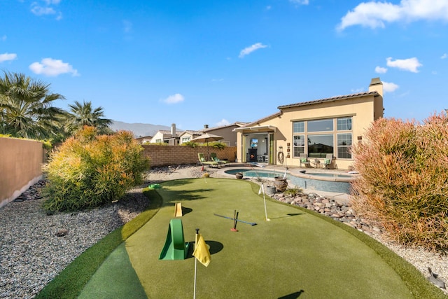 exterior space with a patio area and a pool with hot tub