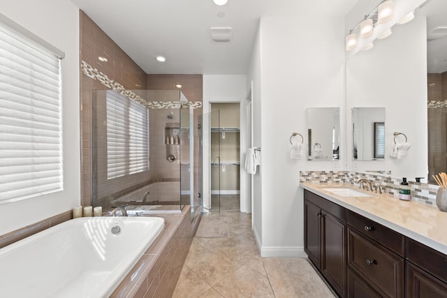 bathroom with shower with separate bathtub, tile patterned flooring, and vanity