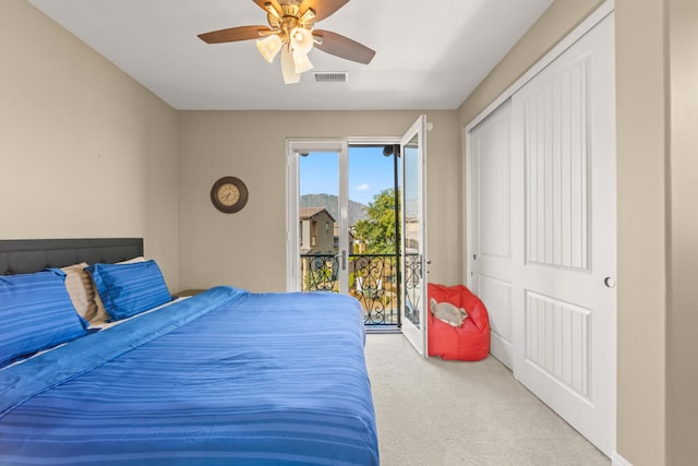 bedroom with light carpet, a closet, ceiling fan, and access to outside