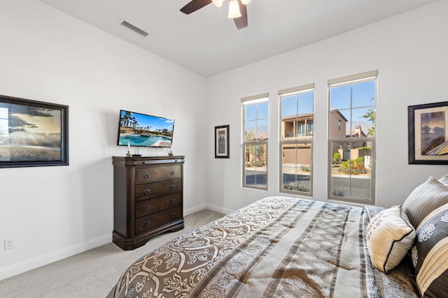 bedroom with ceiling fan and light colored carpet