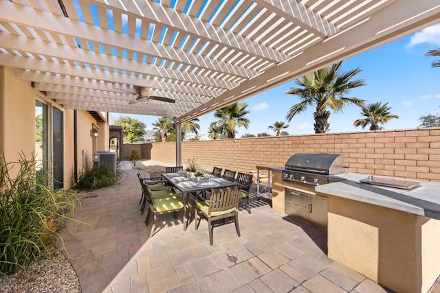 view of patio with grilling area, a pergola, ceiling fan, and exterior kitchen