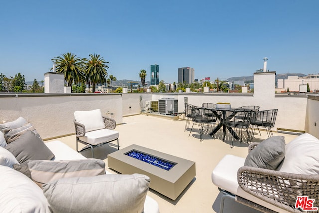 view of patio with a fire pit and central AC unit