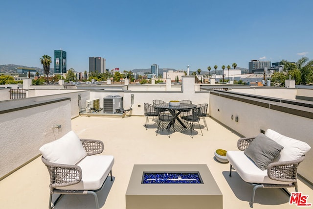 view of patio featuring an outdoor fire pit and central air condition unit