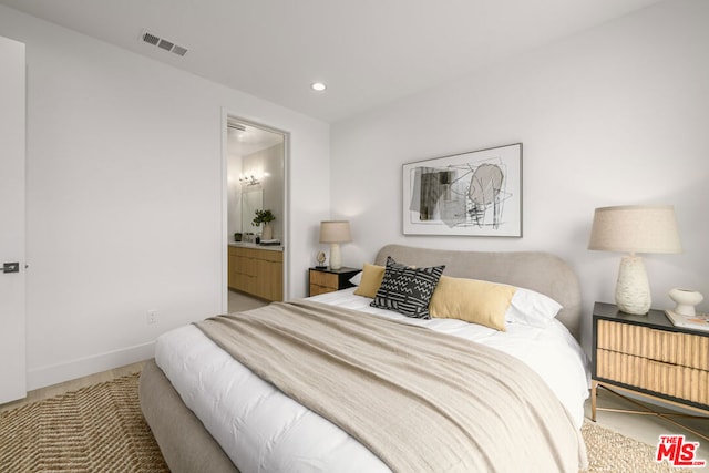 bedroom with carpet floors and ensuite bath