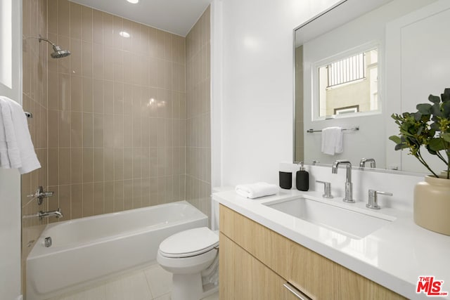 full bathroom with tile patterned flooring, vanity, toilet, and tiled shower / bath