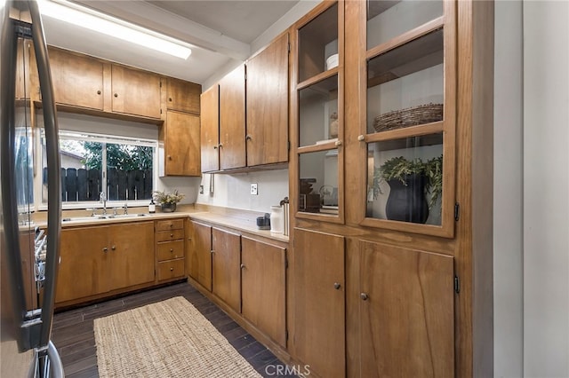 kitchen featuring beamed ceiling, sink, and dark wood-type flooring