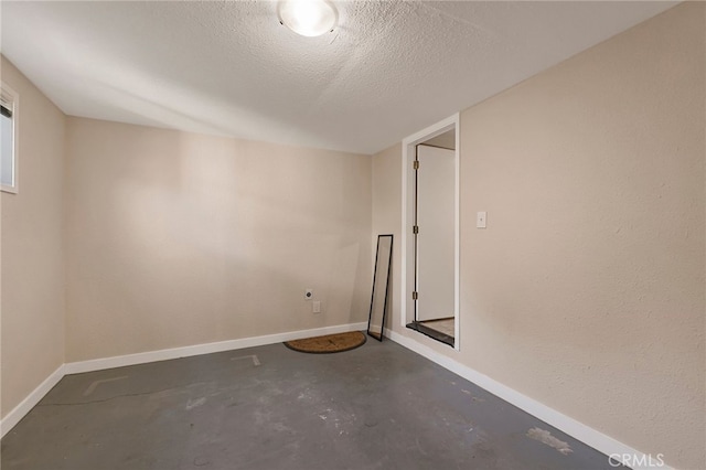 unfurnished room featuring a textured ceiling