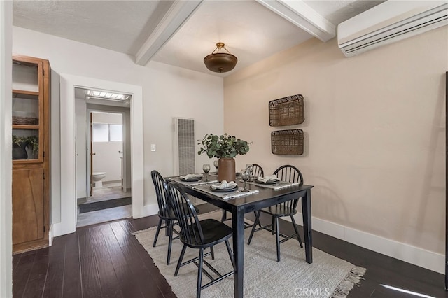 dining space with beam ceiling, dark wood-type flooring, and a wall unit AC