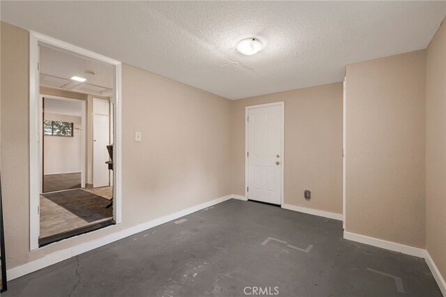 empty room with a textured ceiling