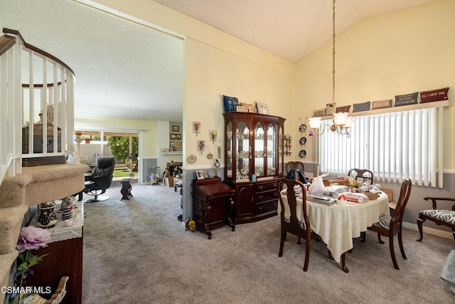 carpeted dining area with an inviting chandelier, a brick fireplace, and high vaulted ceiling