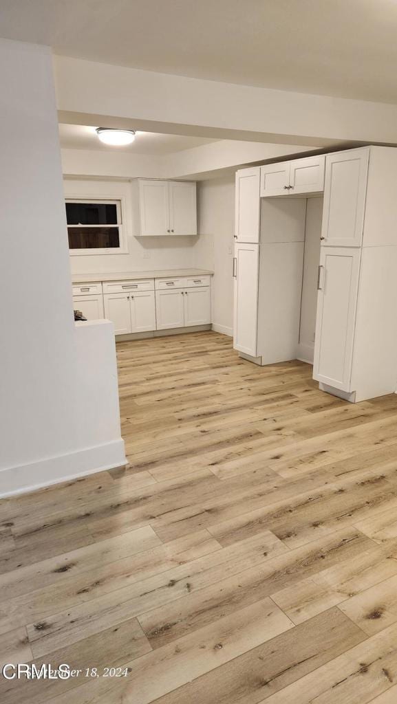 kitchen with white cabinetry and light hardwood / wood-style floors