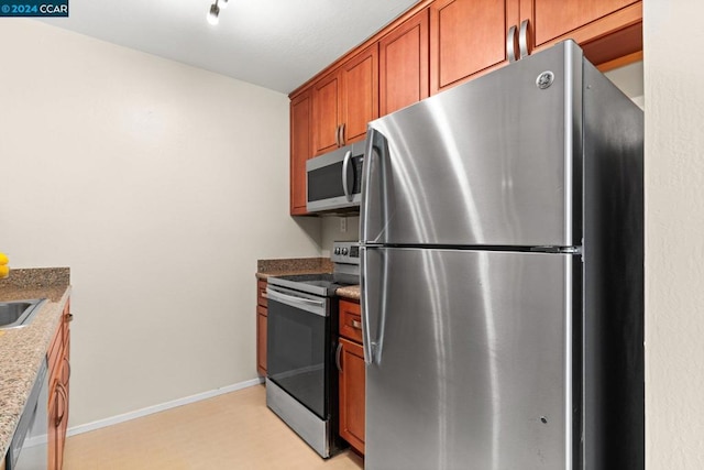 kitchen featuring light stone countertops and stainless steel appliances