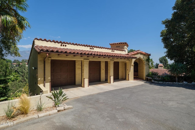 mediterranean / spanish home with a garage