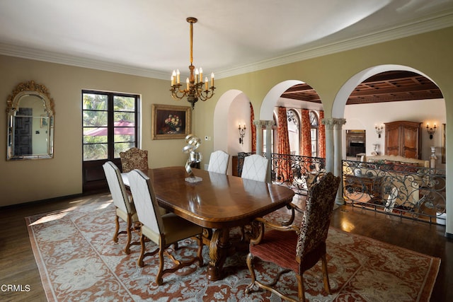 dining area featuring a notable chandelier, dark hardwood / wood-style floors, and ornamental molding