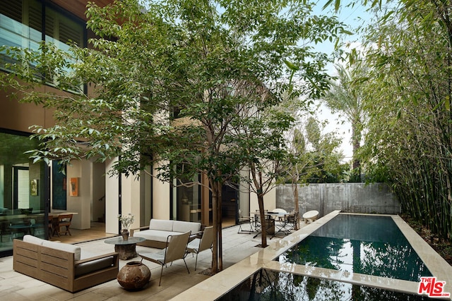 view of swimming pool with an outdoor living space and a patio area