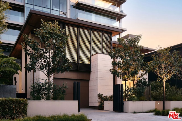 view of outdoor building at dusk