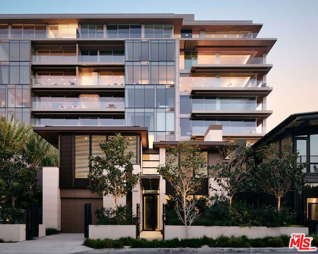 view of outdoor building at dusk