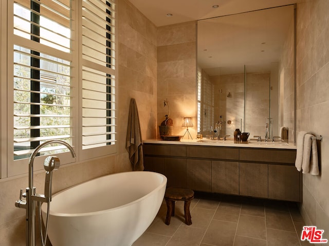 bathroom featuring tile walls, vanity, shower with separate bathtub, and tile patterned floors