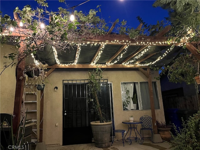 exterior entry at twilight featuring a patio area