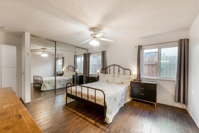 bedroom featuring ceiling fan, a textured ceiling, a closet, and dark hardwood / wood-style flooring