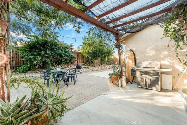 view of patio featuring grilling area and a pergola