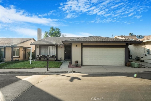 ranch-style house featuring a garage and a front lawn