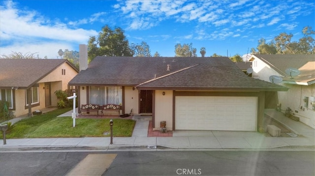 view of front of home featuring a garage and a front lawn