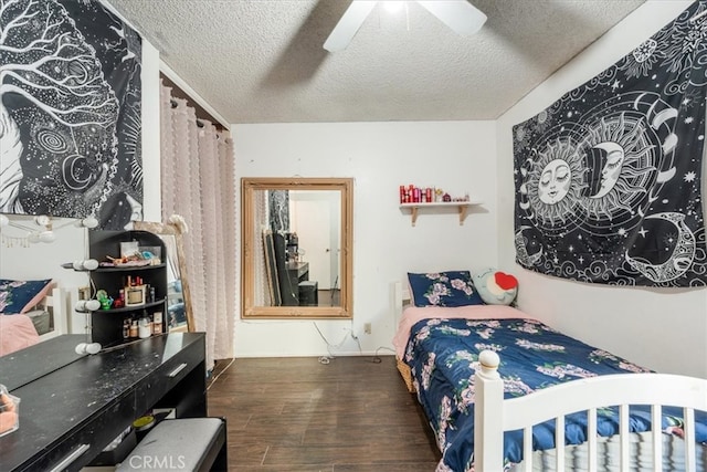 bedroom featuring ceiling fan, dark wood-type flooring, and a textured ceiling