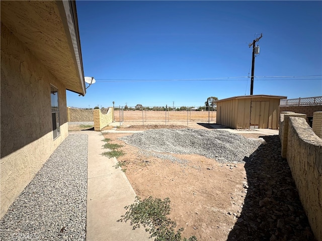 view of yard with a patio and a storage unit