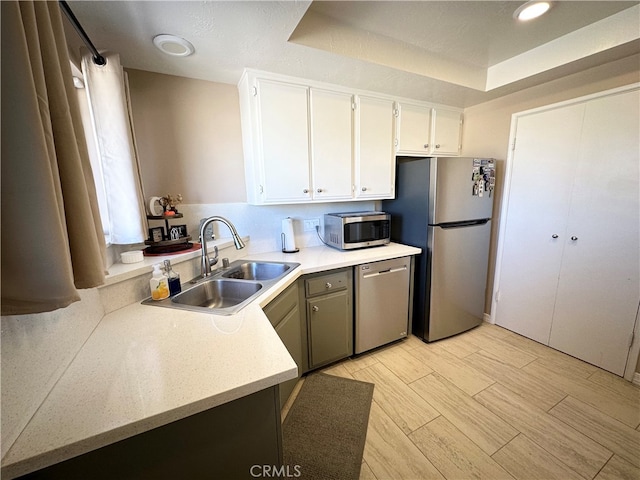 kitchen featuring white cabinets, appliances with stainless steel finishes, and sink