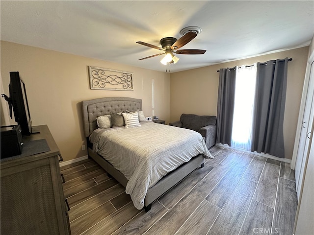 bedroom featuring ceiling fan and dark wood-type flooring