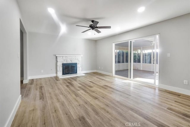 unfurnished living room with ceiling fan and light hardwood / wood-style flooring