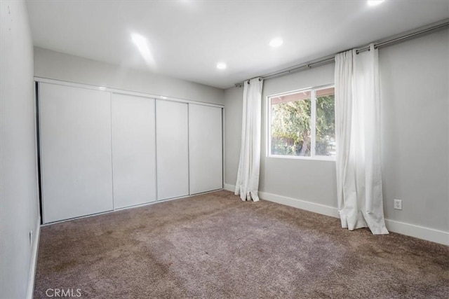 unfurnished bedroom featuring a closet and carpet flooring