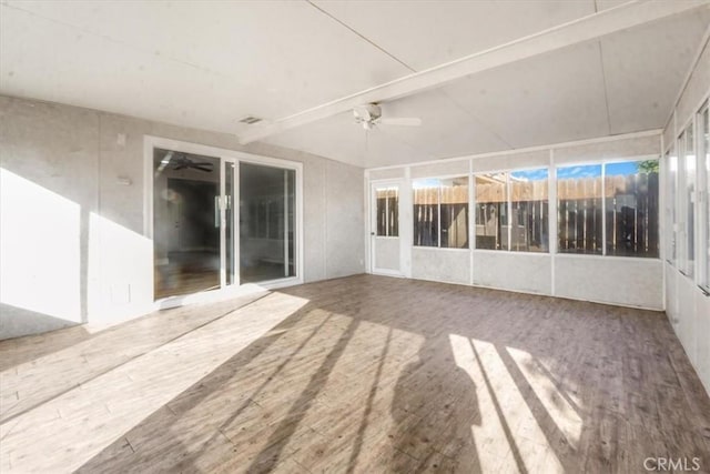 unfurnished sunroom with beam ceiling