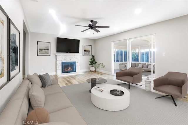 living room featuring ceiling fan and hardwood / wood-style floors