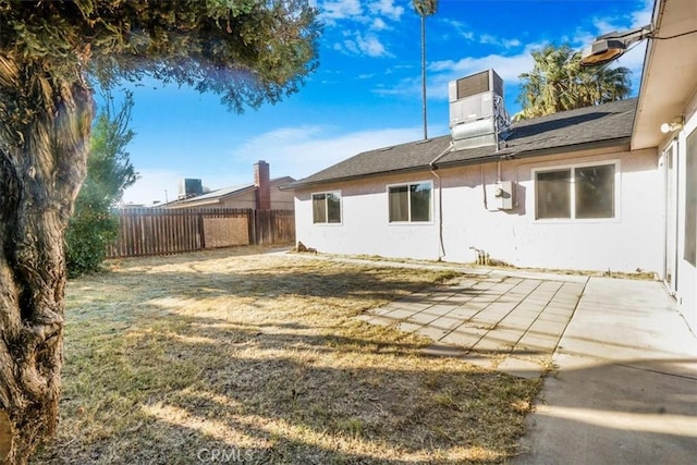 rear view of house featuring a patio area and a lawn