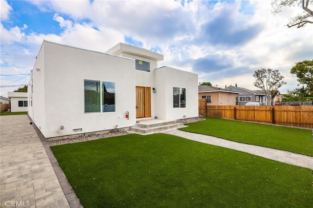 rear view of property with a yard